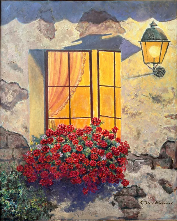 Warm glowing window with red flowers and an old wall lantern.
