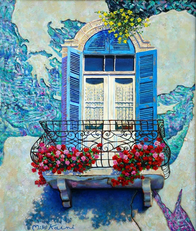 Blue Mediterranean balcony with flowers and textured walls.
