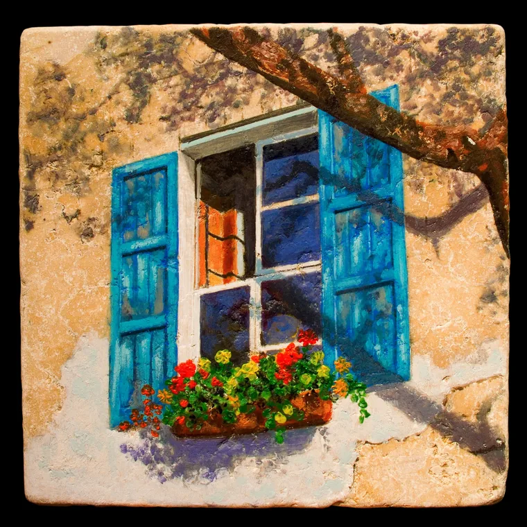Blue-shuttered window with flowers and a tree branch.